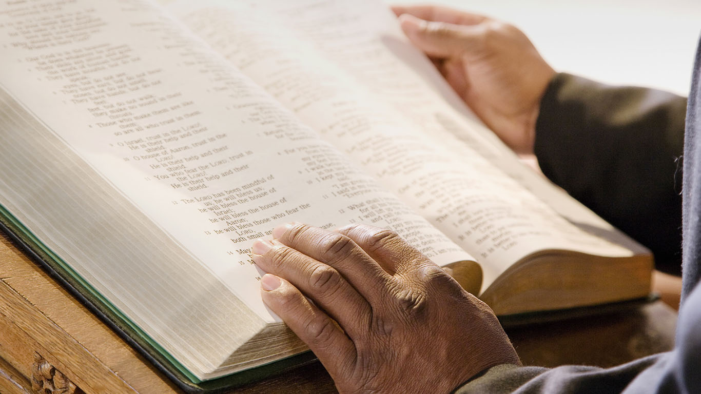 Open Bible on Church Altar With Preacher's Hands